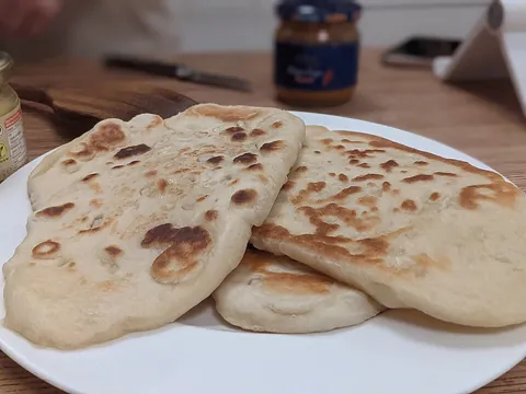 naan: a type of round, flat bread baked in a tandoor popular in South and Central Asian cuisine