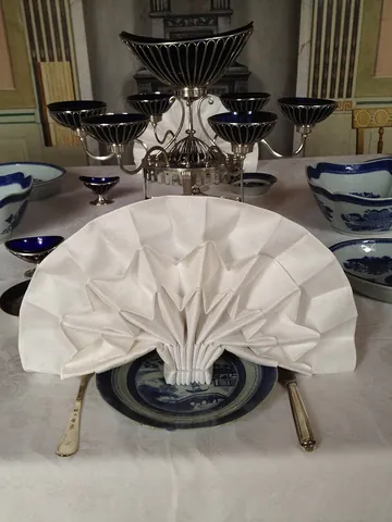 napkin: a serviette; a (usually rectangular) piece of cloth or paper used at the table for wiping the mouth...