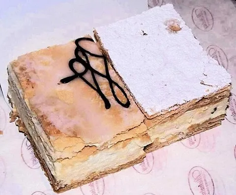 napoleonka: a Polish type of cream pie made of two layers of puff pastry, filled with whipped cream, crème...