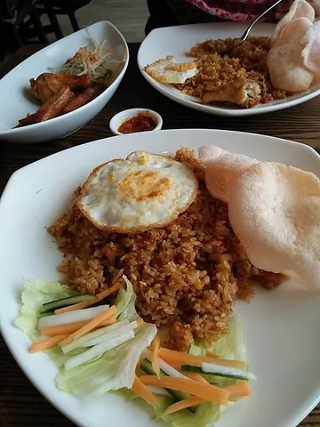 nasi goreng: in Malaysian and Indonesian cookery: a dish of savoury fried rice with a variety of ingredients...