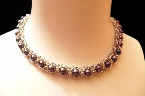 necklace: an article of jewelry that is worn around the neck, most often made of a string of precious metal,...