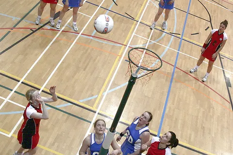 netball: a (usually women's) team sport derived from basketball, with seven players on each side who attempt...
