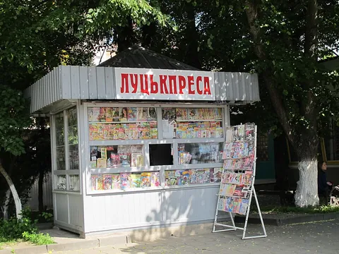 newsstand: an open stall, often on a street, where newspapers and magazines are on sale to the public