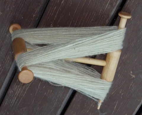 niddy-noddy: a tool used to make skeins from yarn, consisting of a central bar with crossbars at each end,...