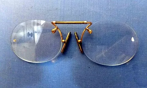 nose glasses: a style of eyeglasses without earpieces, often attached to a cord or ribbon allowing them to be...