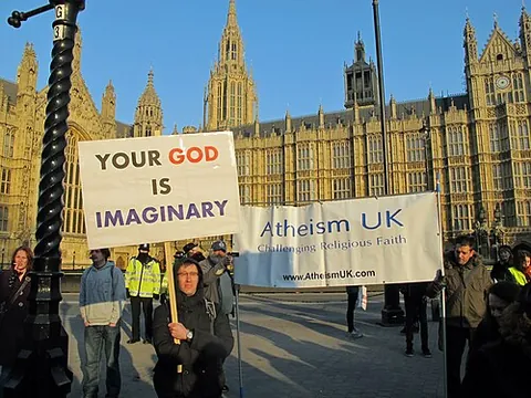 nullifidian: synonym of atheist (“a person who does not believe in deities or gods”)