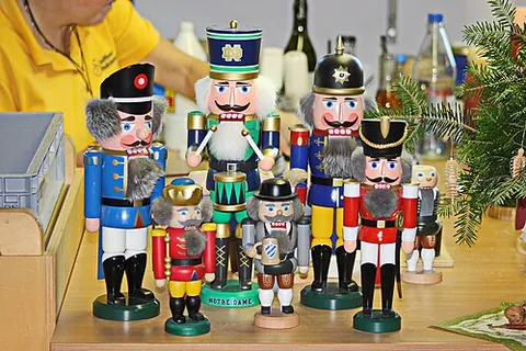 nutcracker doll: a decorative wooden figurine, traditionally German, shaped like a soldier, king, or other figure,...