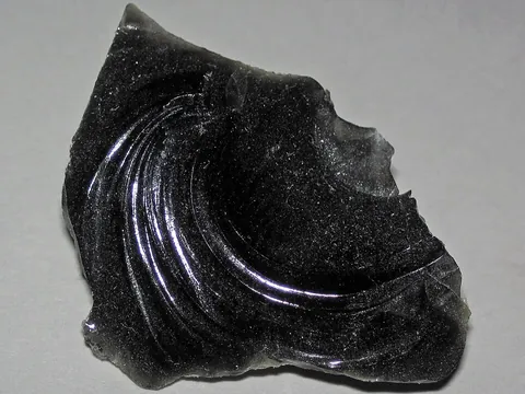 obsidian: a type of naturally occurring black glass produced by volcanoes