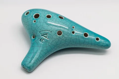 ocarina: a woodwind musical instrument that is closed at both sides to produce an enclosed space, and...