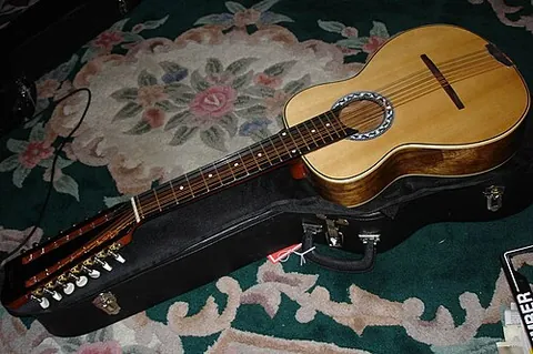 octavina: a stringed musical instrument resembling the guitar