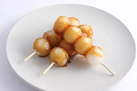odango: a Japanese sweet round dumpling made from mochiko (rice flour), eaten off a stick. Related to mochi
