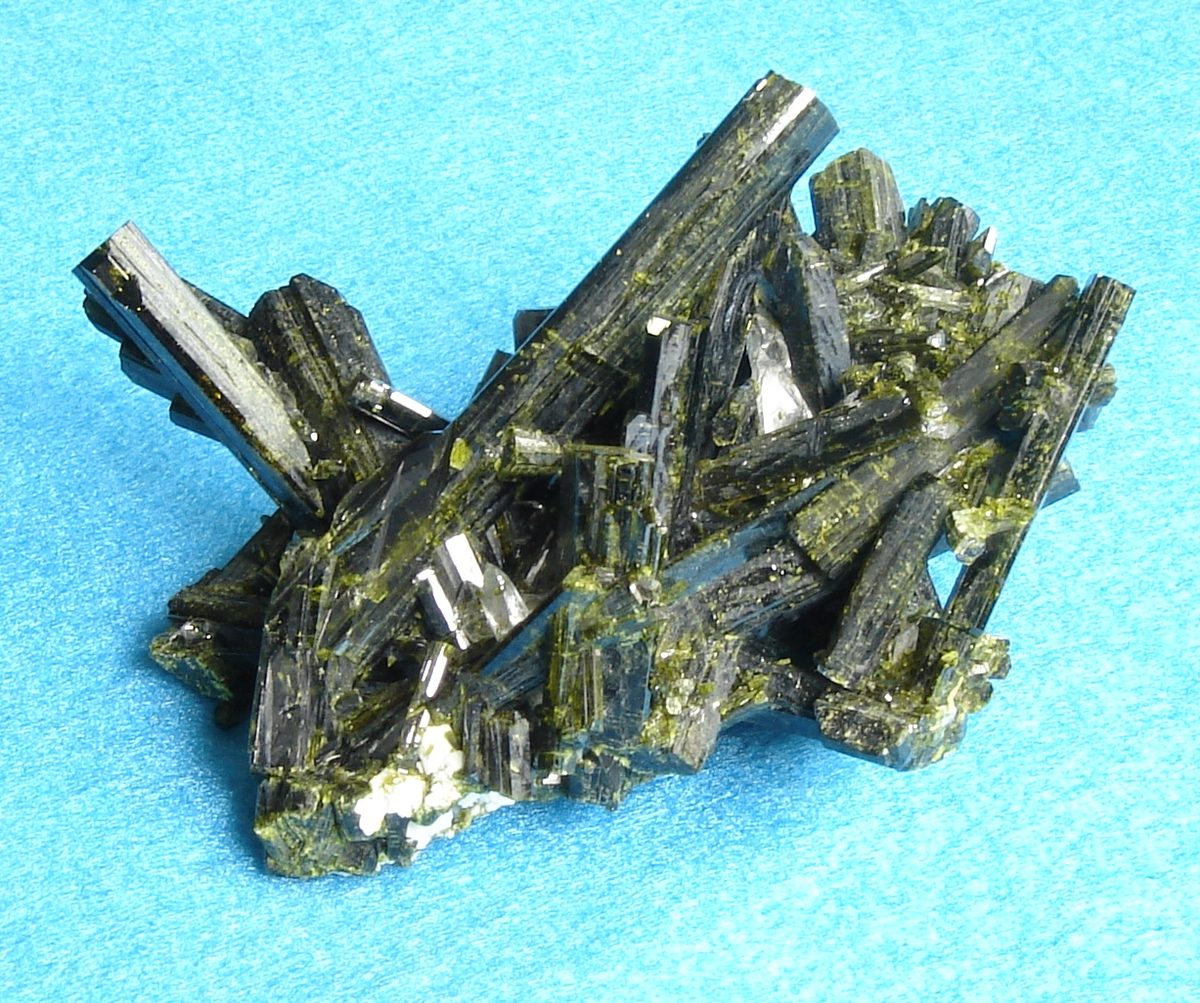 epidote: any of a class of mixed calcium iron aluminium sorosilicates found in metamorphic rocks
