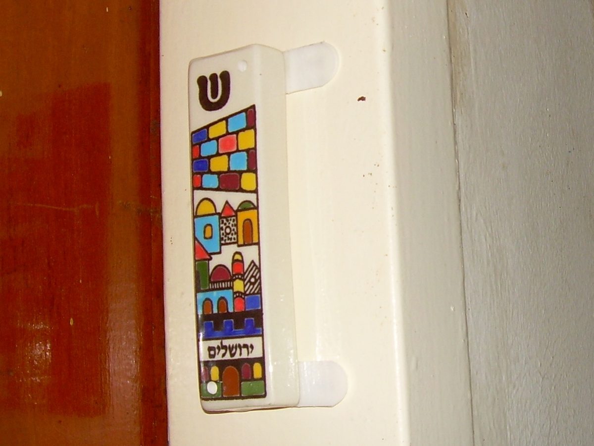 mezuzah: a piece of parchment inscribed with specific Hebrew verses from the Torah (Deuteronomy 6:4–9 and...