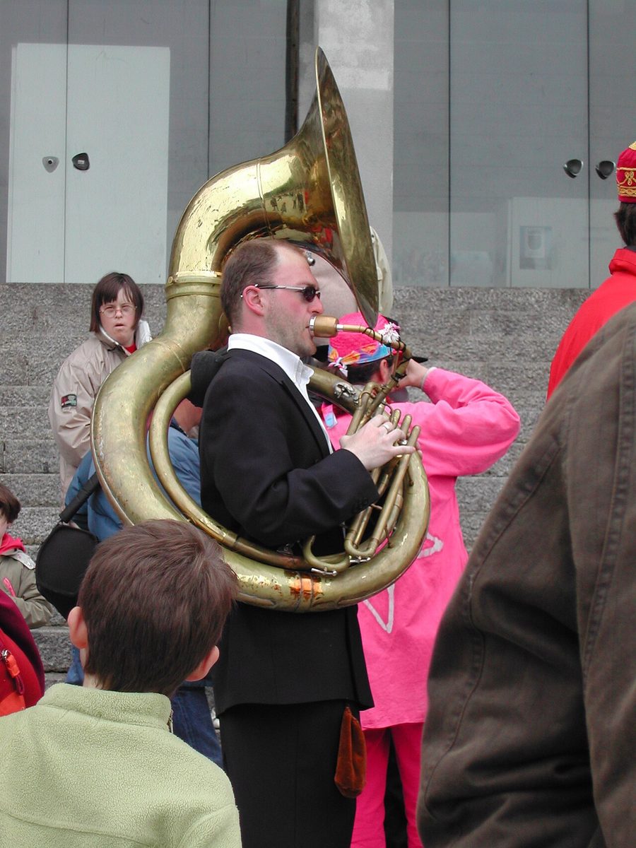 sousaphone: a valved brass instrument with the same length as a tuba, but shaped differently so that the bell...