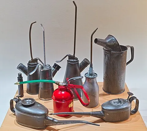 oilcan: a container with a long spout, for holding oil and delivering it in drops or small quantities for...