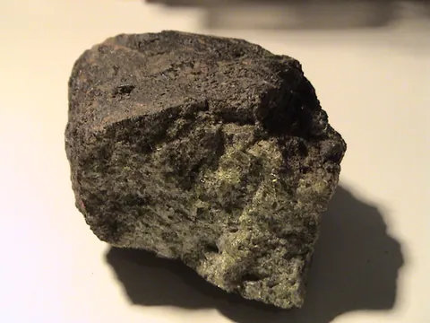 olivine: any of a group of olive green magnesium-iron silicate minerals that crystallize in the orthorhombic...