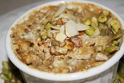 om ali: a traditional Egyptian dessert resembling bread pudding, typically made with layers of puff pastry...