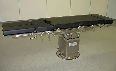 operating table: a table on which a patient lies during a surgical operation