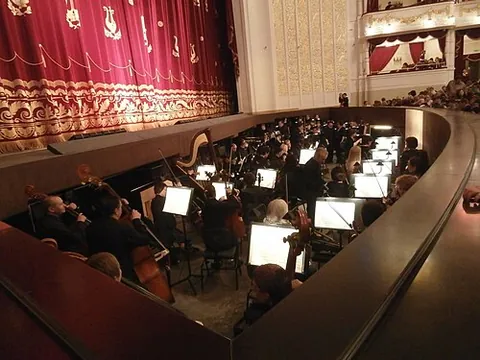 orchestra pit: a sunken area in front of a stage in which musicians, largely hidden from view, play music to...