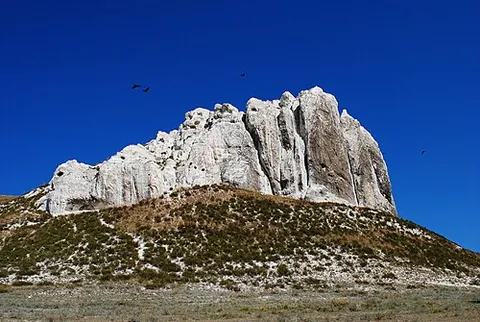 outcrop: a piece of land that stands out (usually into water) from the land surrounding