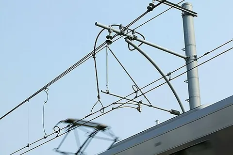 overhead line: a wire or cable, suspended between poles or by a catenary, used to provide trains, trams or trolley...