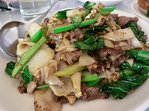 pad see ew: a stir fry Thai dish made from wide rice noodles, egg, broccoli, a protein, and a sweet soy sauce