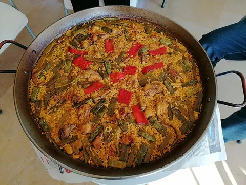paella: a savory Valencian dish made of rice, cooked in a frying pan with vegetables and meat or shellfish