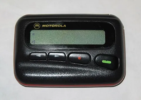 pager: a wireless telecommunications device that receives text or voice messages