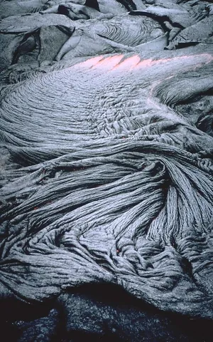 pahoehoe: a form of lava flow of basaltic rock, usually dark-colored with a smooth or ropey surface. It is...