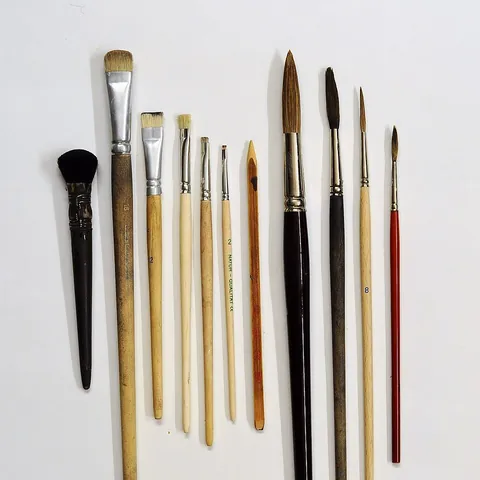 paintbrush: a thin brush for applying paint