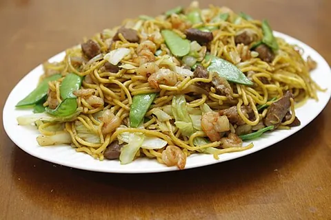pancit canton: a Filipino dish of stir-fried egg noodles with meat, vegetables, soy sauce and other seasonings