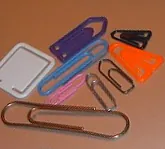 paper clip: a small, folded, wire or plastic device used to hold sheets of paper together