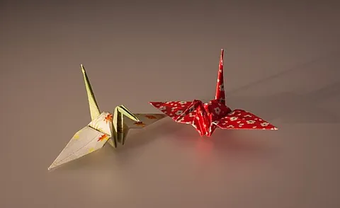 paper crane: a representation of the Japanese red-crowned crane made out of folded paper, a classic origami...