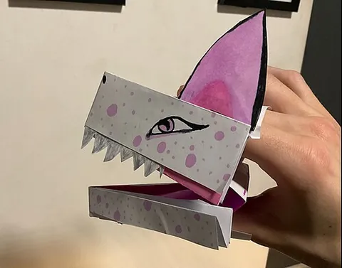 paper dragon: a hand puppet shaped like the head of a dragon or other animal, usually made from paper or...
