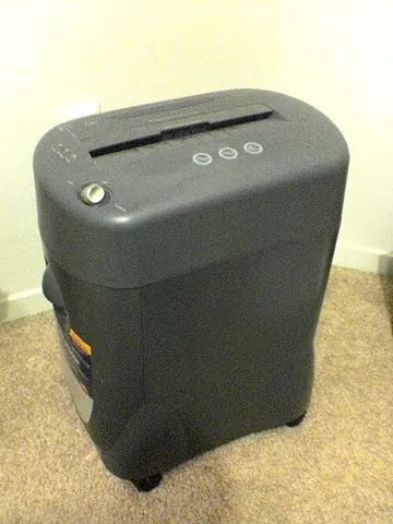 paper shredder: a machine that cuts paper into small, thin pieces