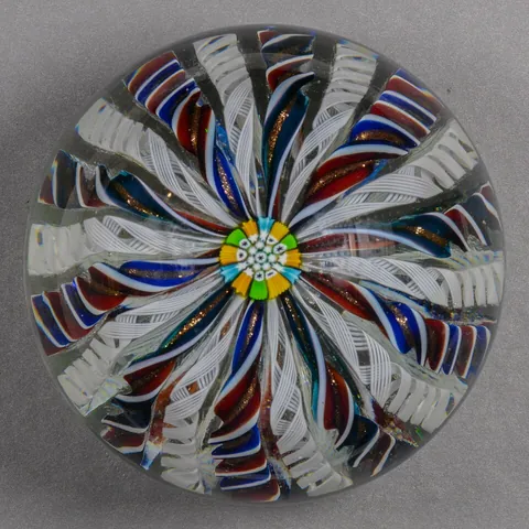 paperweight: a small, decorative, somewhat weighty object placed on one or more pieces of paper to keep them...