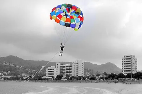parasailing: a recreational activity where a person is towed behind a vehicle (usually a boat) while attached to...