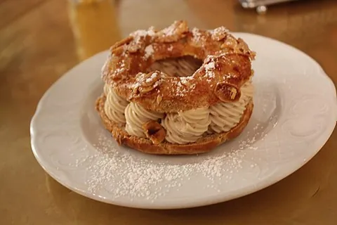 paris-brest: a dessert consisting of a ring (representing a bicycle wheel) of choux pastry filled with praline...