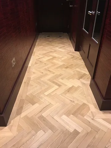 parquet: a wooden floor made of wooden tiles or veneers arranged in a decorative geometrical pattern