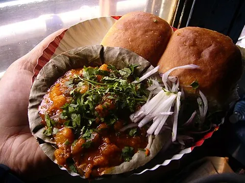 pav bhaji: a Maharashtrian fast food dish of vegetable curry served on bread and garnished with coriander and...