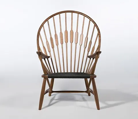 peacock chair: a style of chair originating in Denmark, having a backrest made of individual spindles, fanning out...