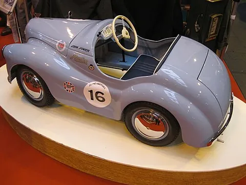 pedal car: a toy car large enough to ride in, typically for small children, which is operated by pedals