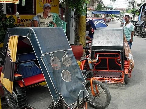 pedicab: a tricycle having a hooded cab to seat paying passengers