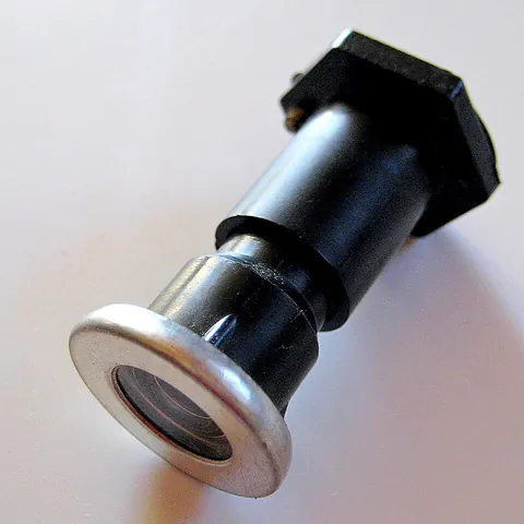 peephole: a small hole, opening, or piece of glass, especially in a door, through which one can look without...