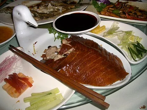 peking duck: a Chinese dish consisting of roasted duck skin, small pancakes, hoisin sauce and other ingredients