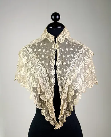 pelerine: a kind of short cape or covering for the shoulders, associated especially with medieval pilgrims...