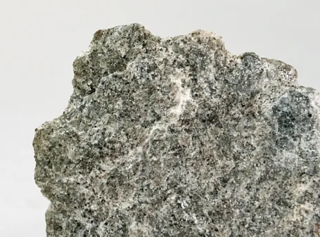 periclase: a cubic crystalline form of magnesium oxide (MgO)