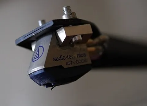 phono cartridge: the component attached to the end of the tone arm of a phonograph turntable that holds the stylus