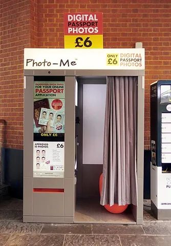 photo booth: a coin-operated kiosk used to take photographs, typically used for passport photographs