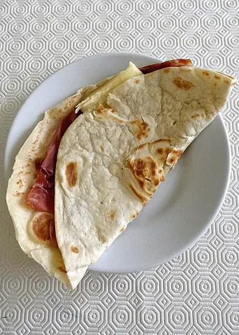 piadina: a thin Italian flatbread, typically prepared in the Romagna historical region